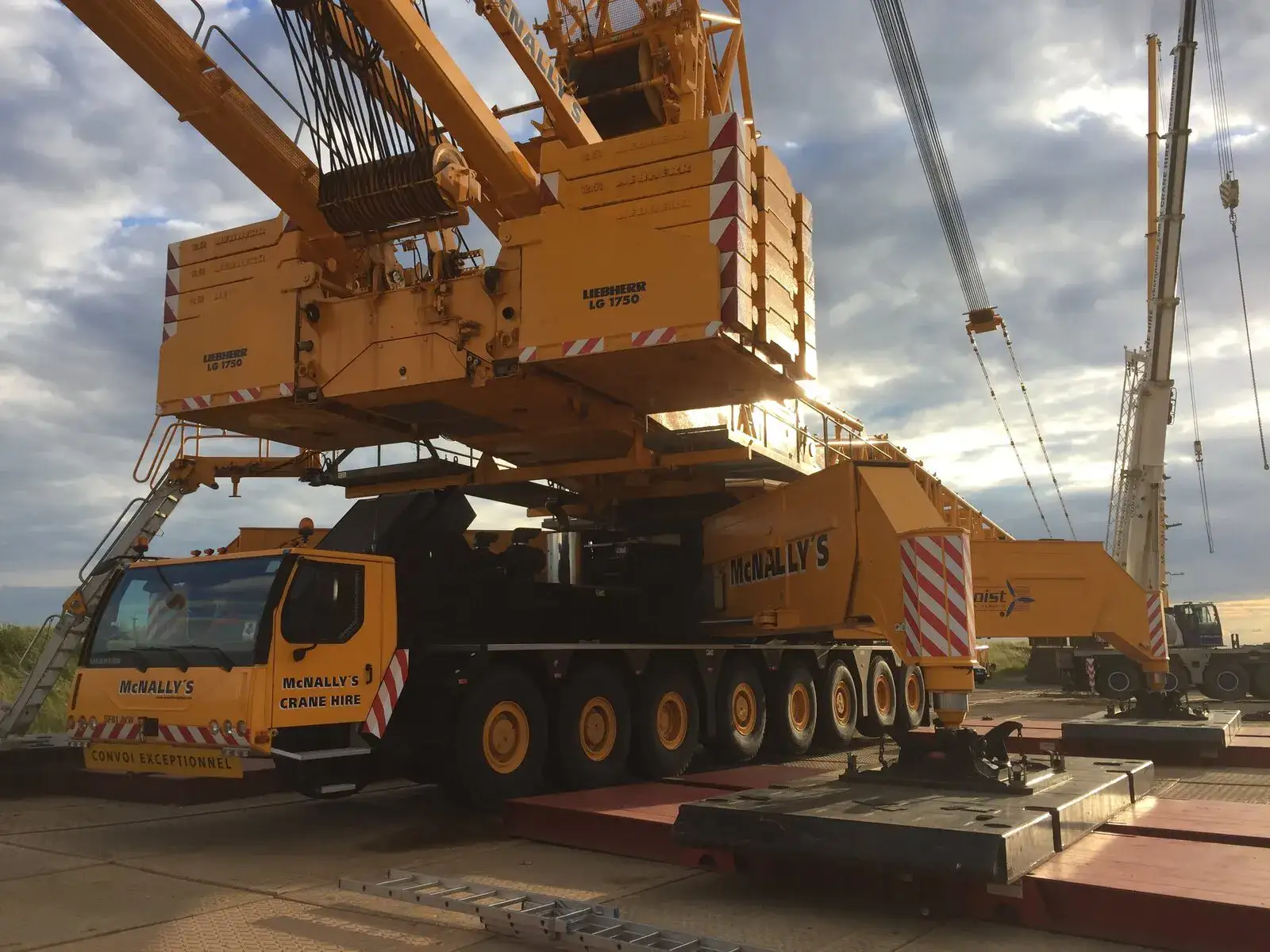 All-terrain crane set up on steel mats, seen from a low angle