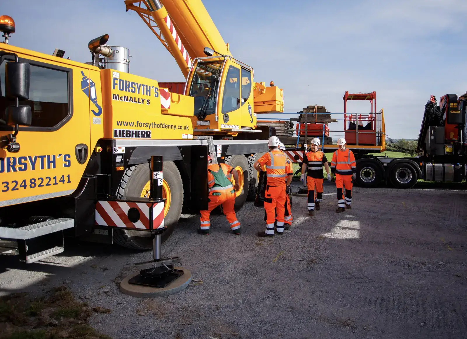 McNally’s crew walking past the crane cab on site