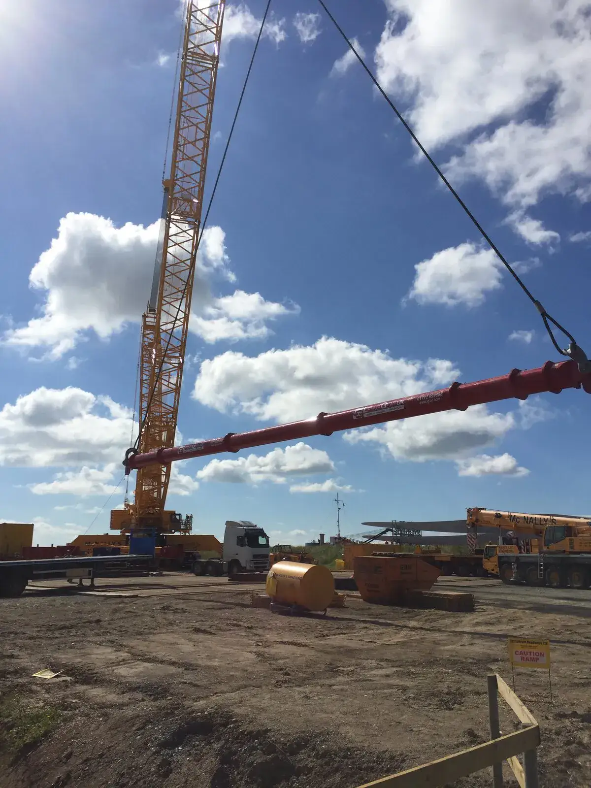LG1750 crawler crane lifting a long red steel section