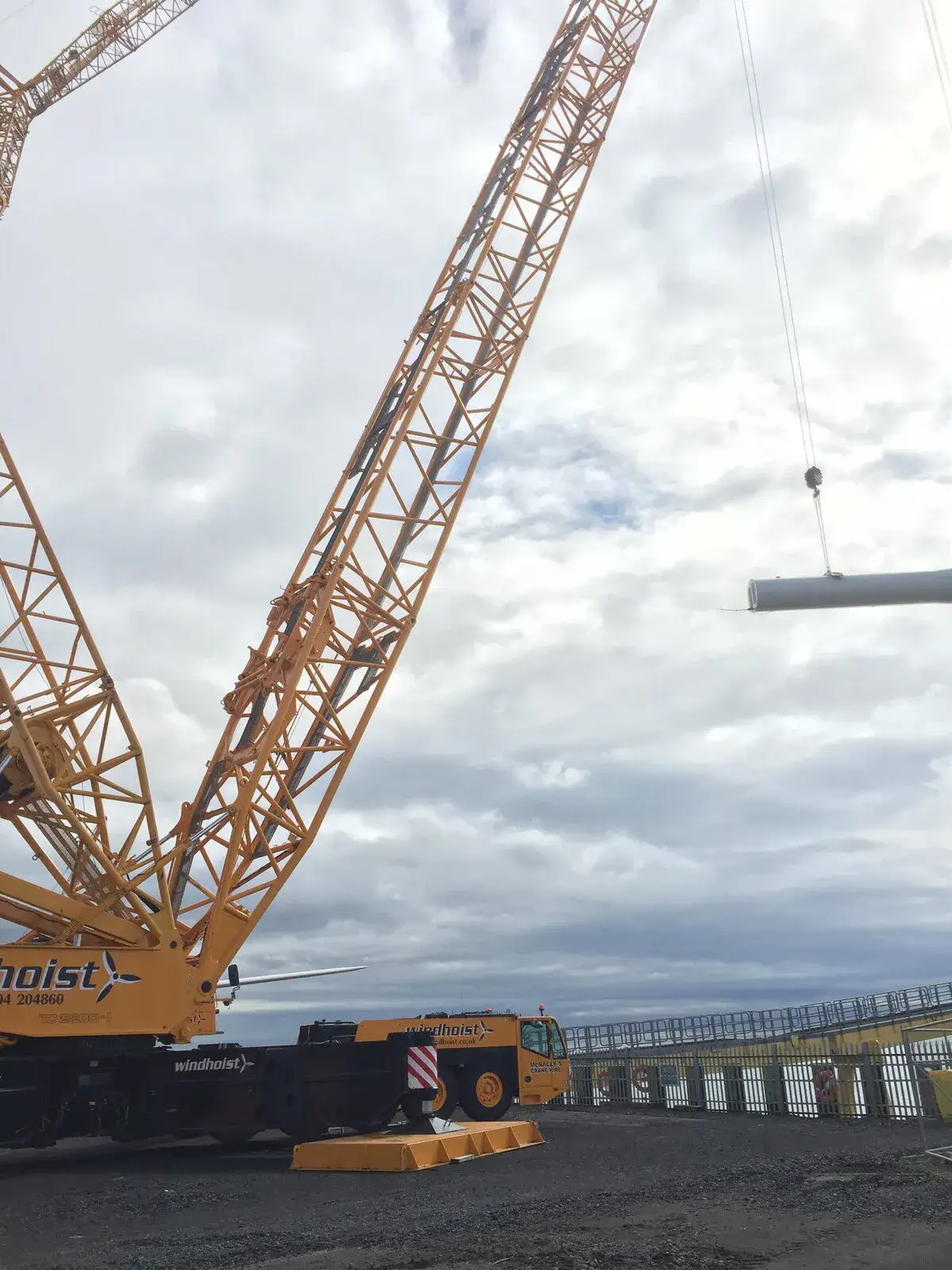 Crawler crane lifting a turbine tower section at Methil