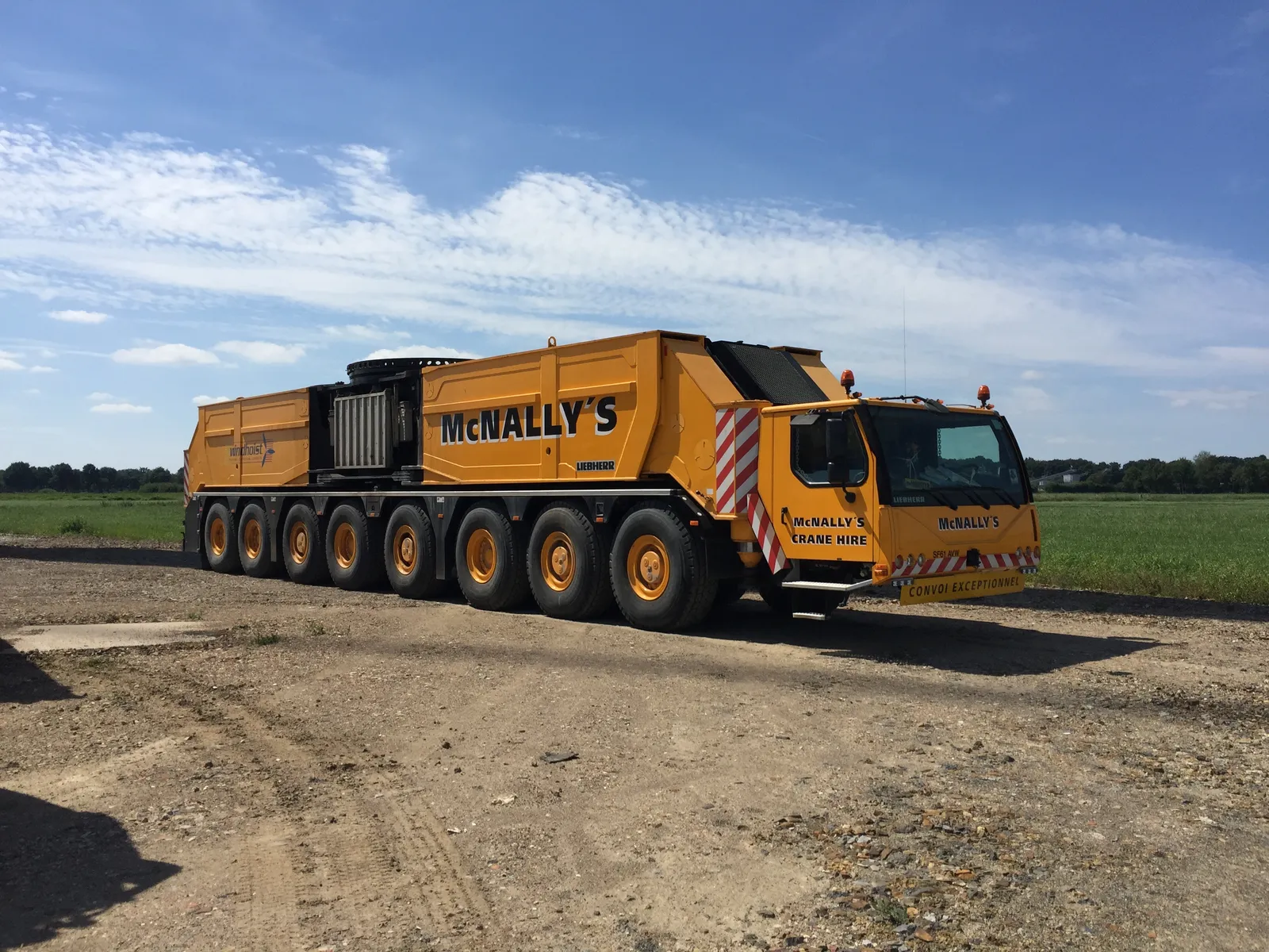 McNally’s all-terrain crane in road configuration on a gravel yard