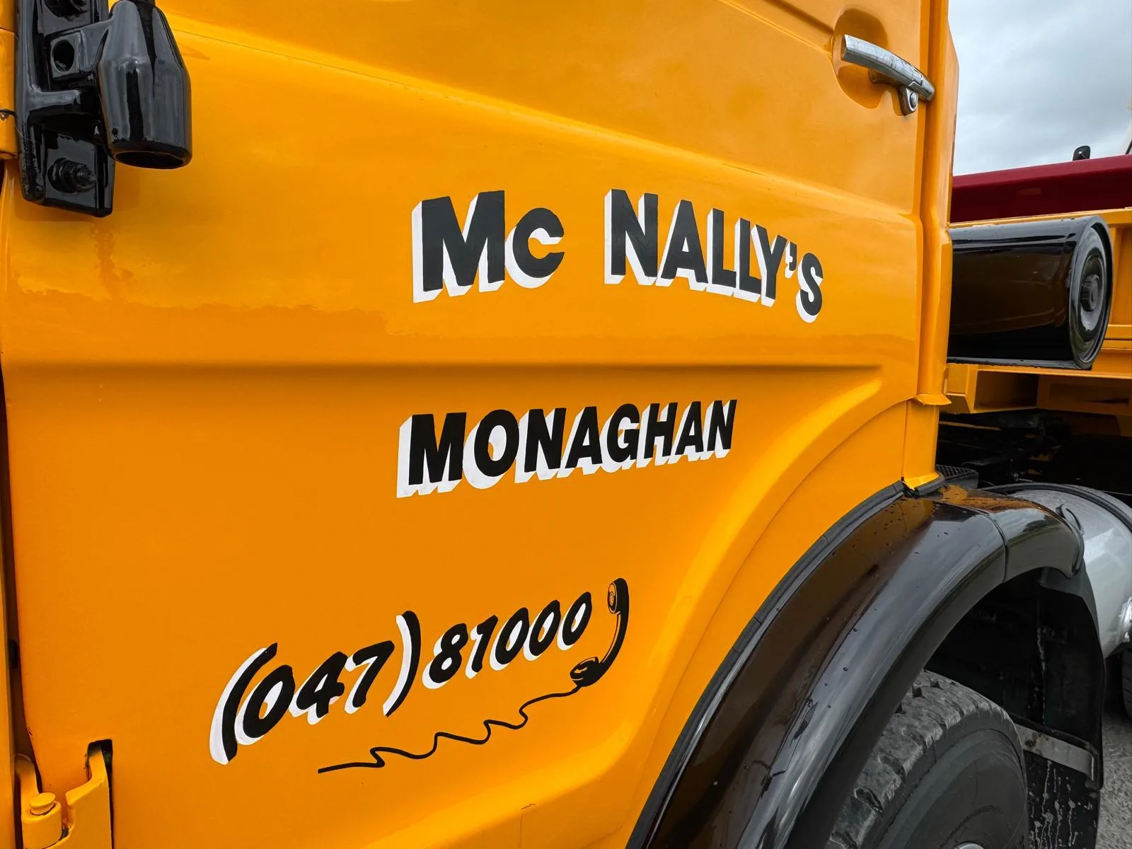 Close-up of the McNally’s Monaghan door livery with the historic telephone number