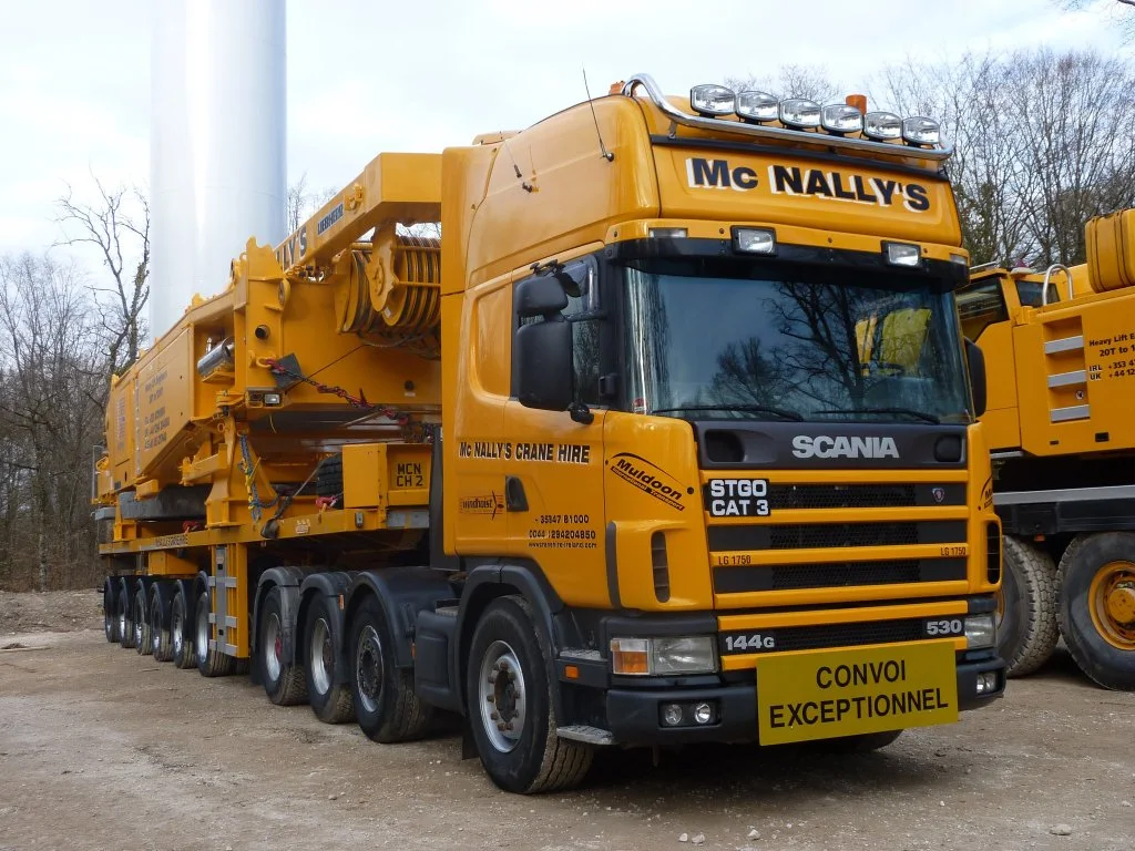 McNally’s Scania tractor unit carrying Liebherr LG 1750 components beside a wind turbine tower