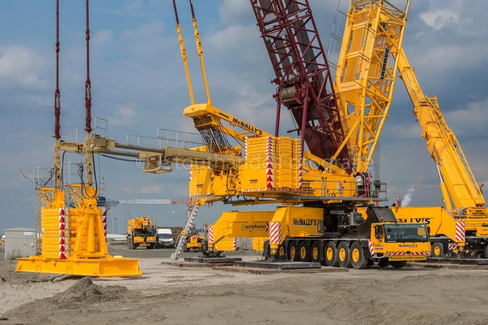 Two crawler cranes and an all-terrain crane on a wind site hardstand
