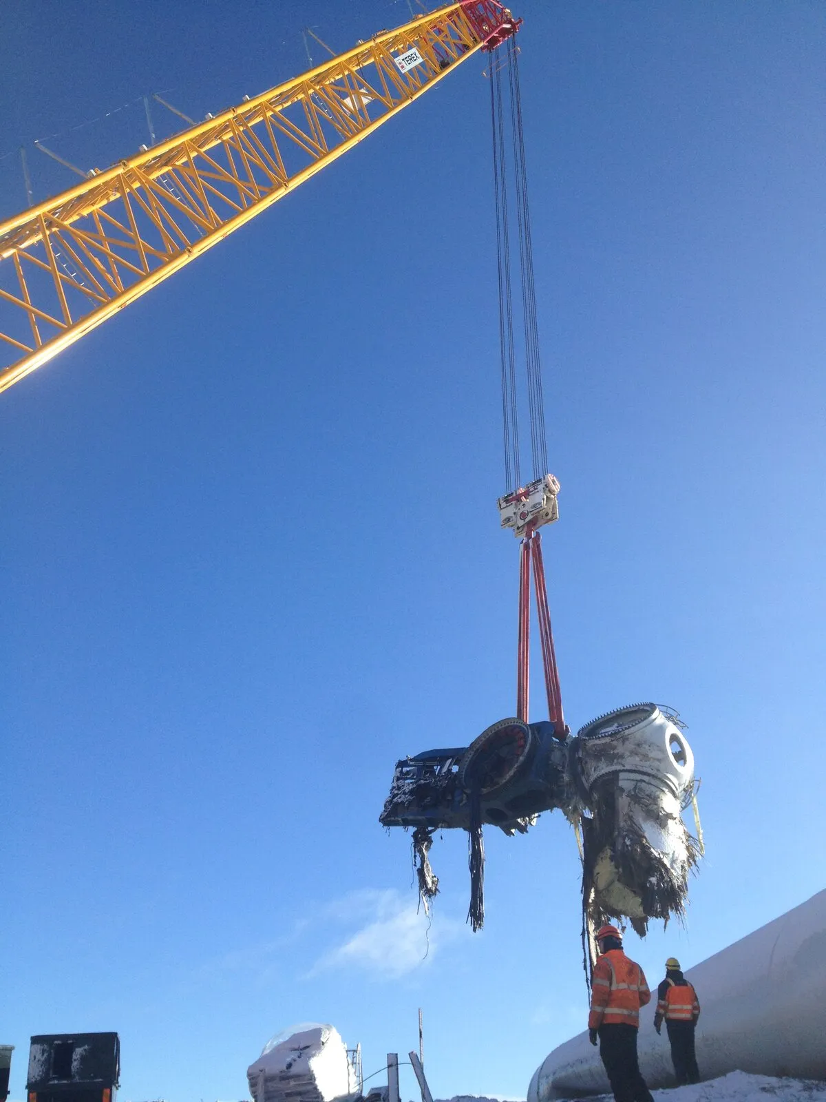 Turbine hub lifted against a clear blue sky