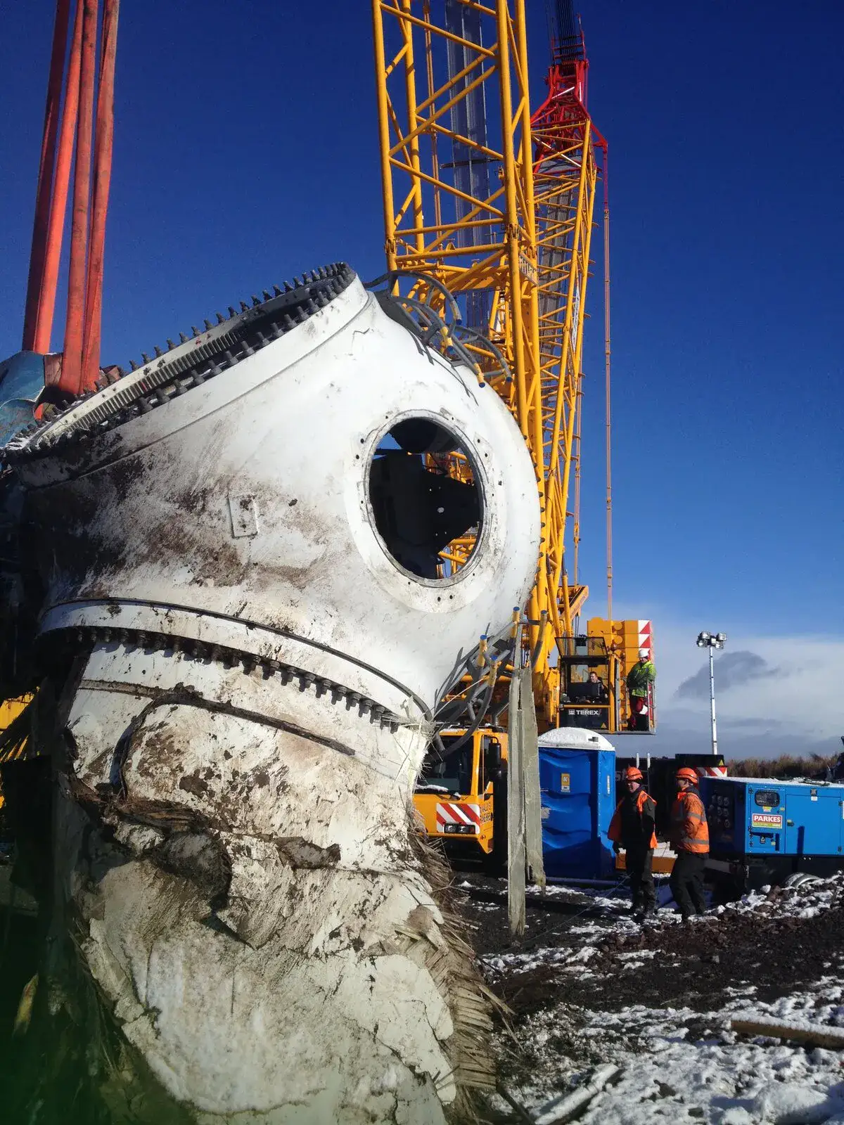 Close-up of a muddy turbine hub landed in the snow