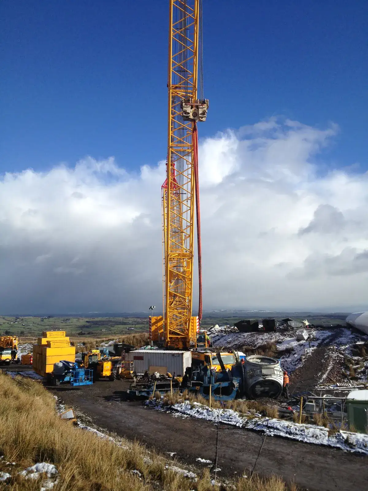 TC2800 crawler crane above the Five Mile Town site under a bank of cloud