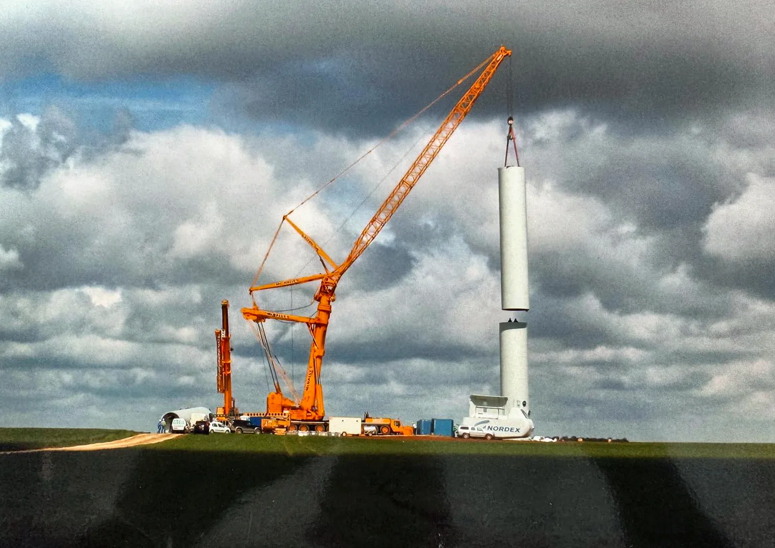 Archive photograph of a McNally’s crane lifting a turbine nacelle section at the quayside