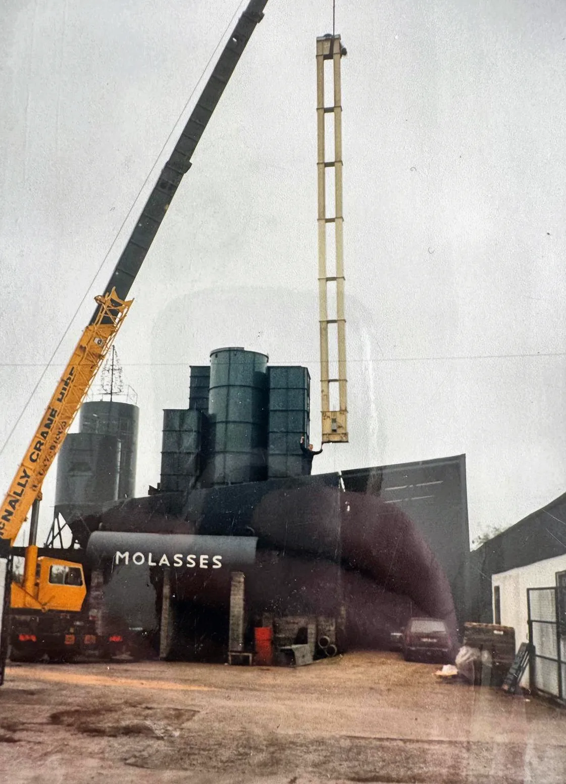 Archive photograph of a McNally’s crane working at the molasses tanks