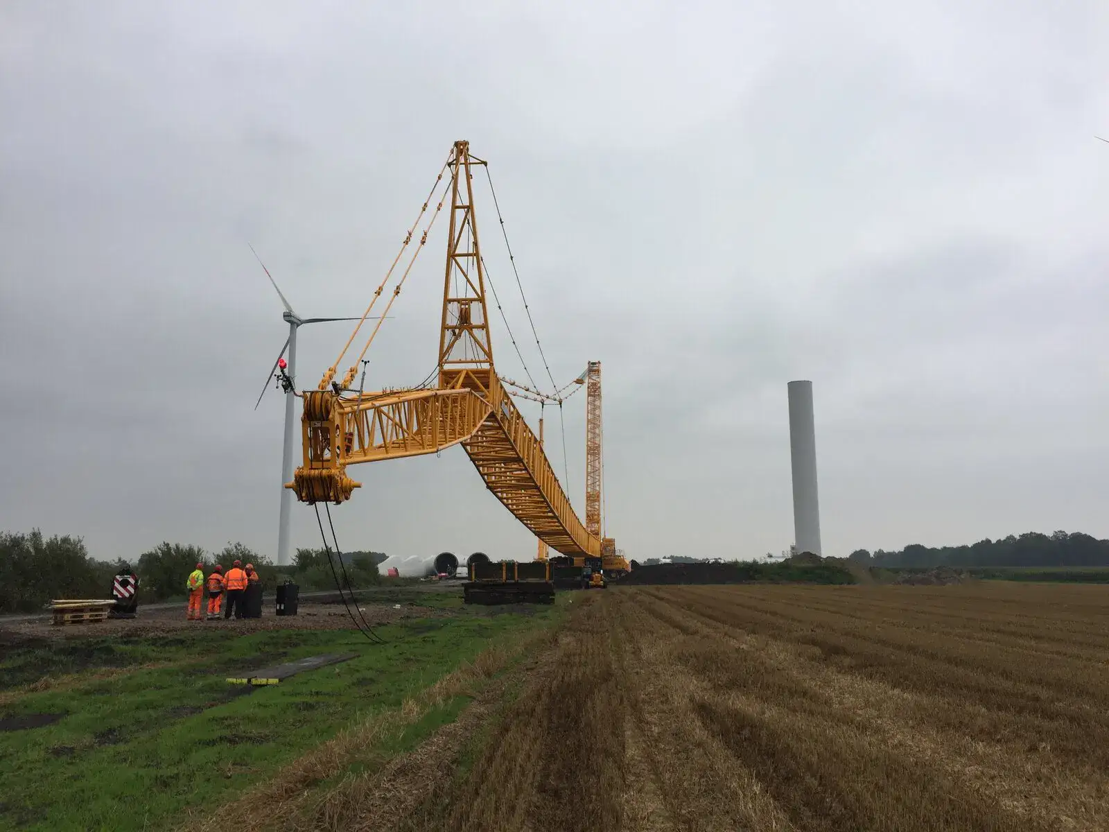McNally’s crawler crane on a wind farm site with a turbine tower behind