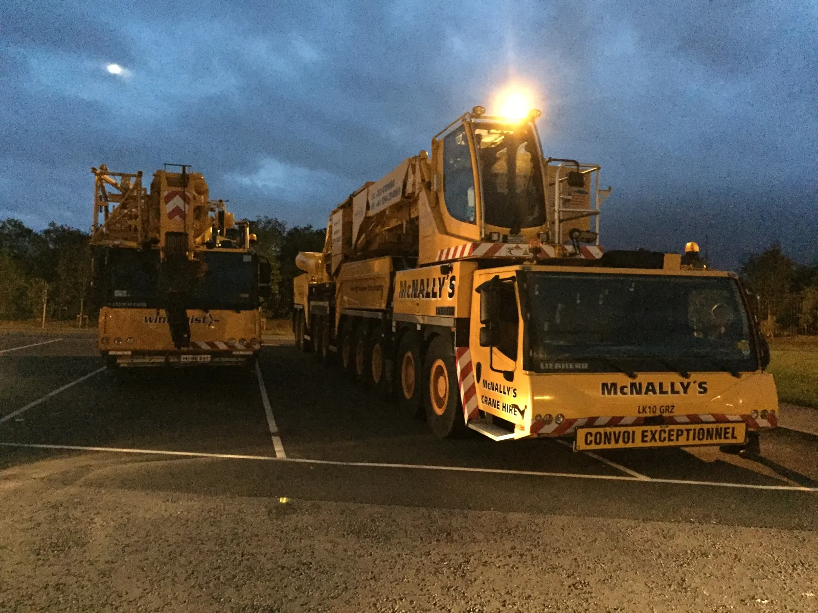 Two McNally’s all-terrain cranes parked up at dusk